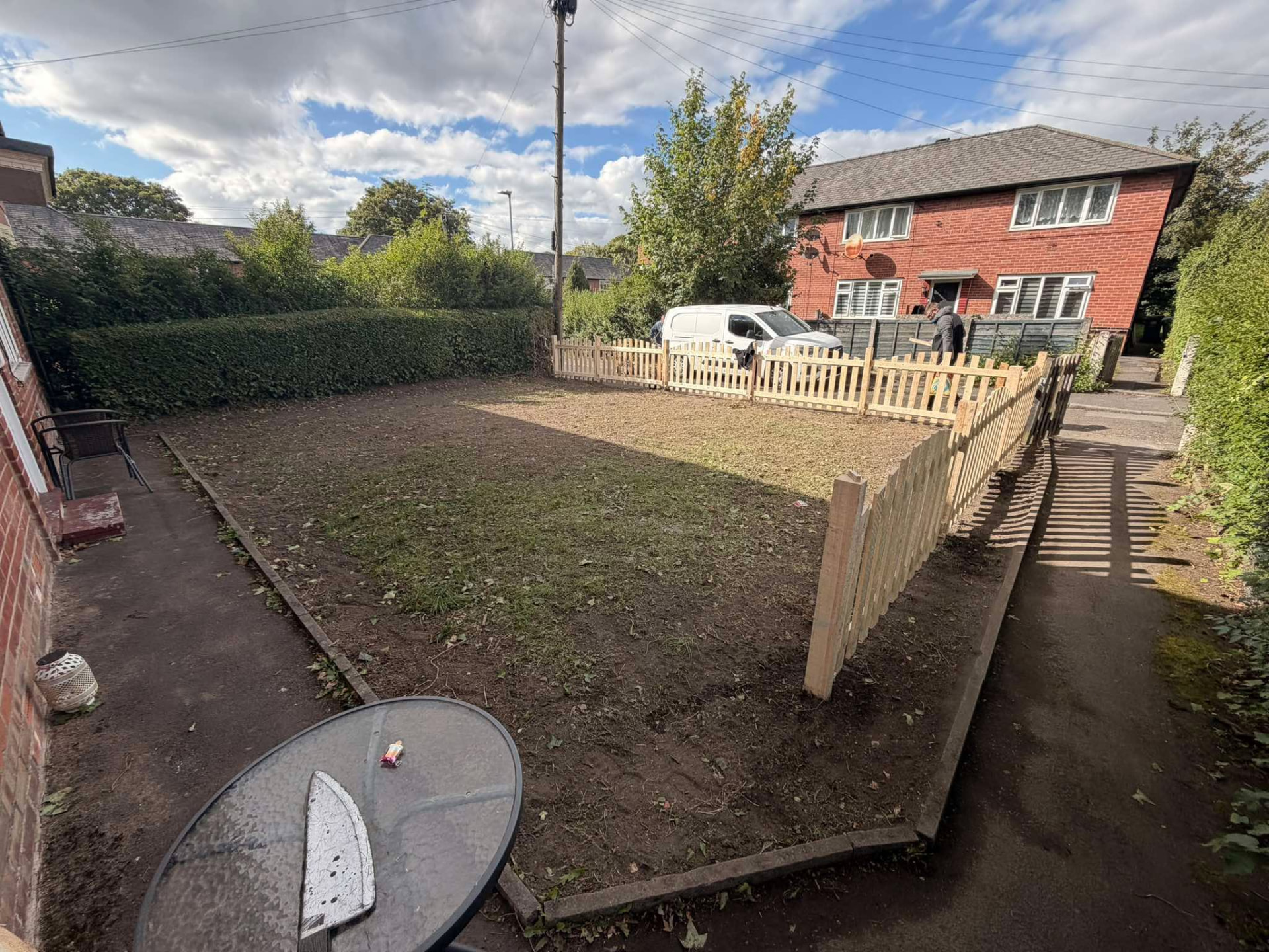 Frontyard transformation — New picket fence and cleared garden space, Manchester